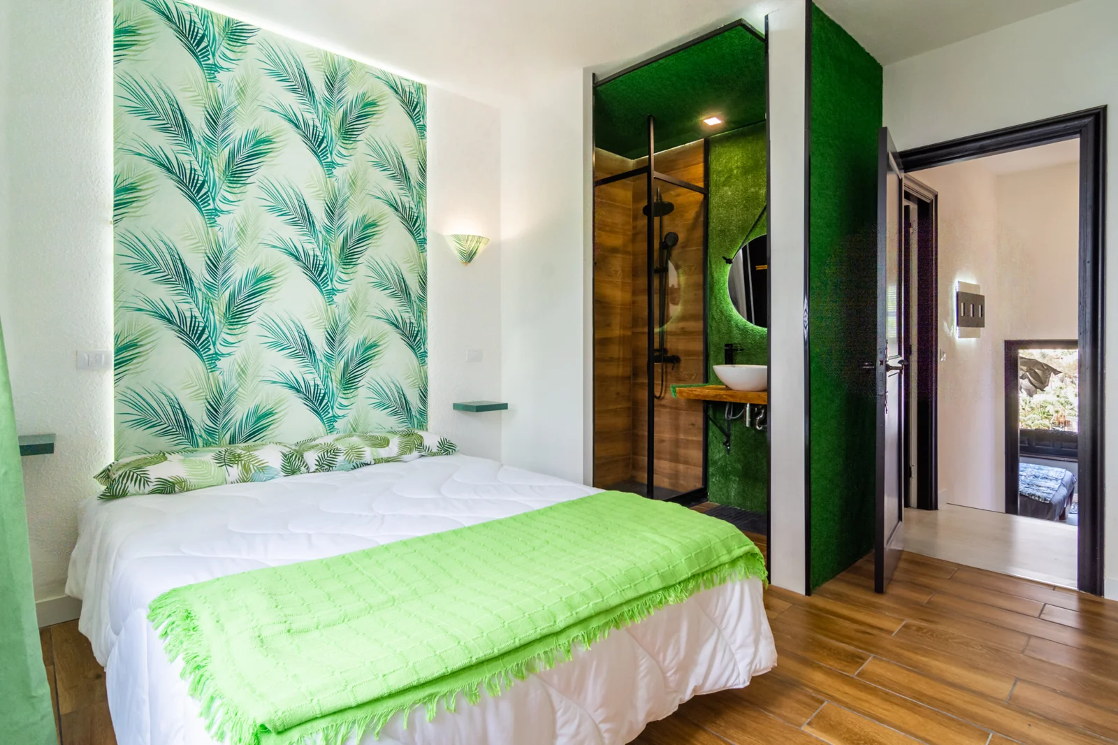 Green bedroom with botanical wallpaper.