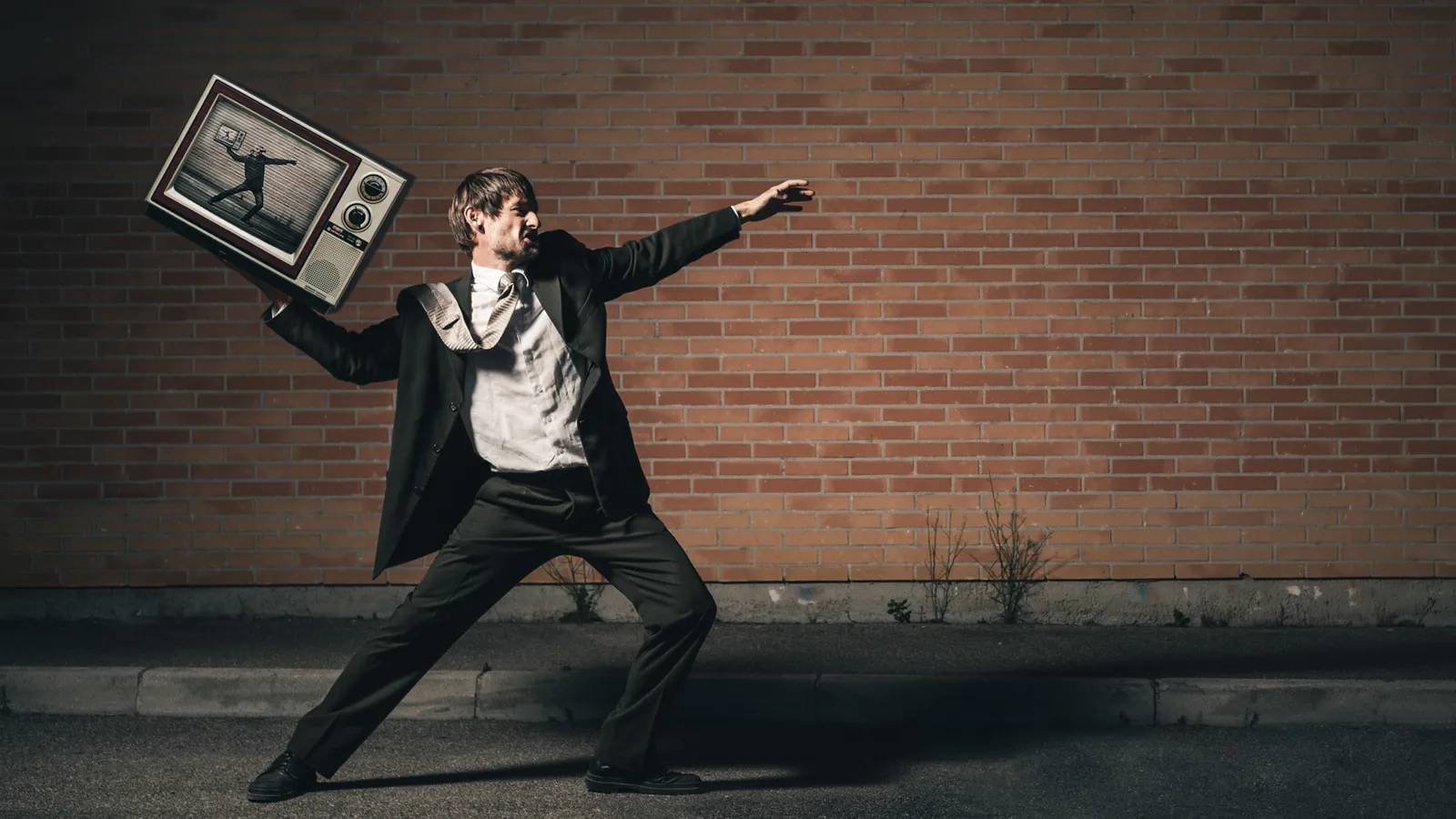 Person in a suit extending their arms with a picture frame