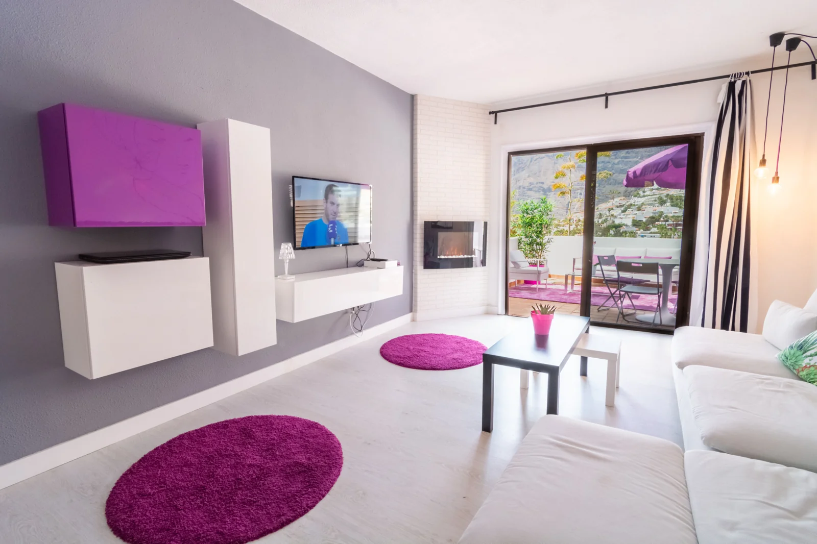 White sofa beside large terrace doors.