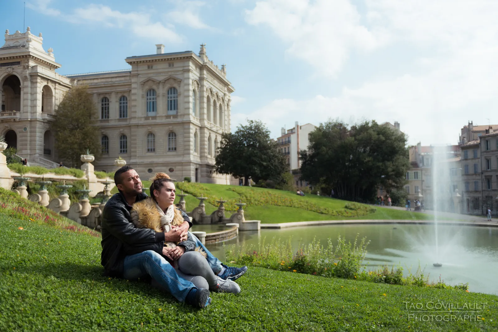 Couple relaxing together on grass.