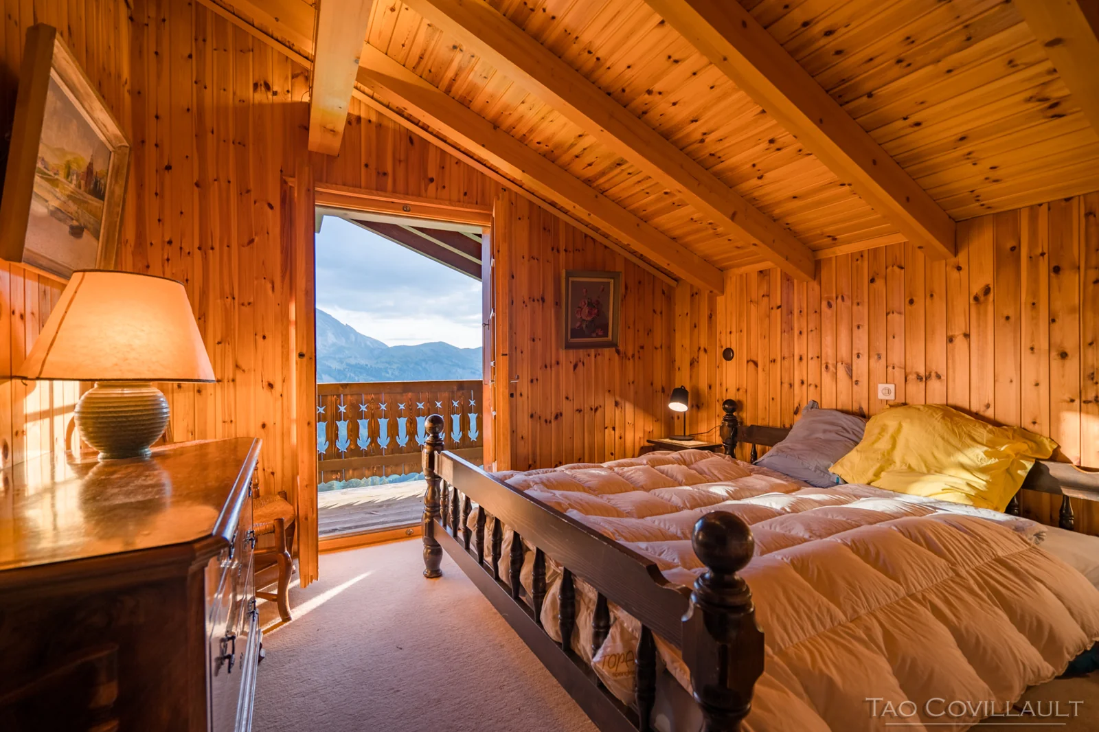 Warm wood-panelled chalet bedroom.