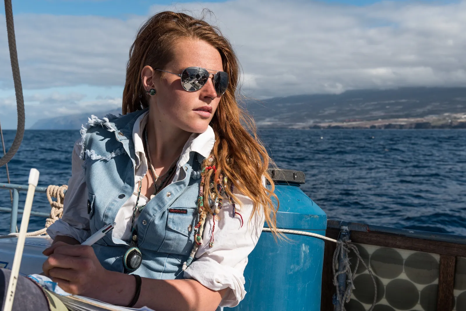 Person in sunglasses seated aboard a boat
