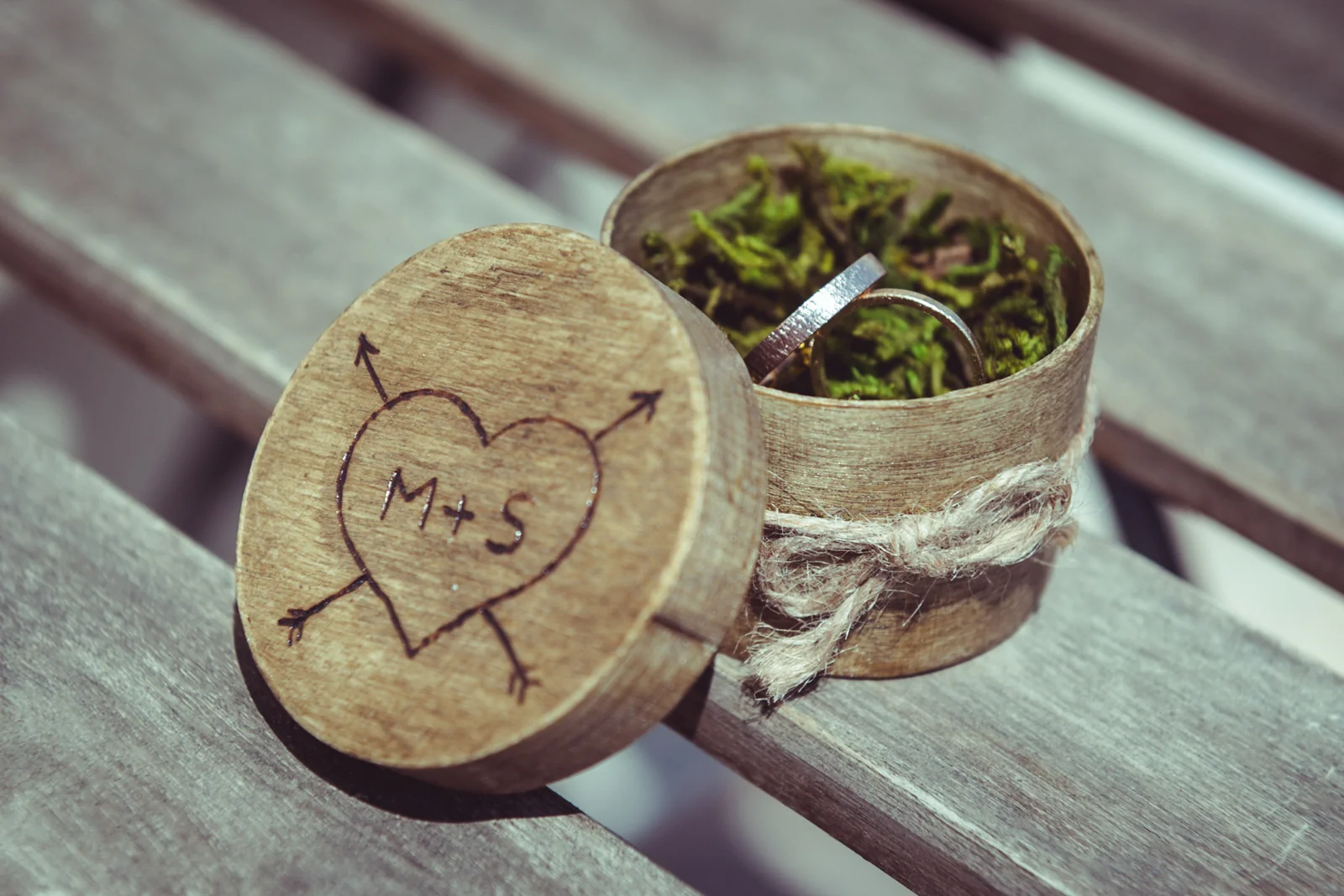 Wedding rings in a rustic wooden box.