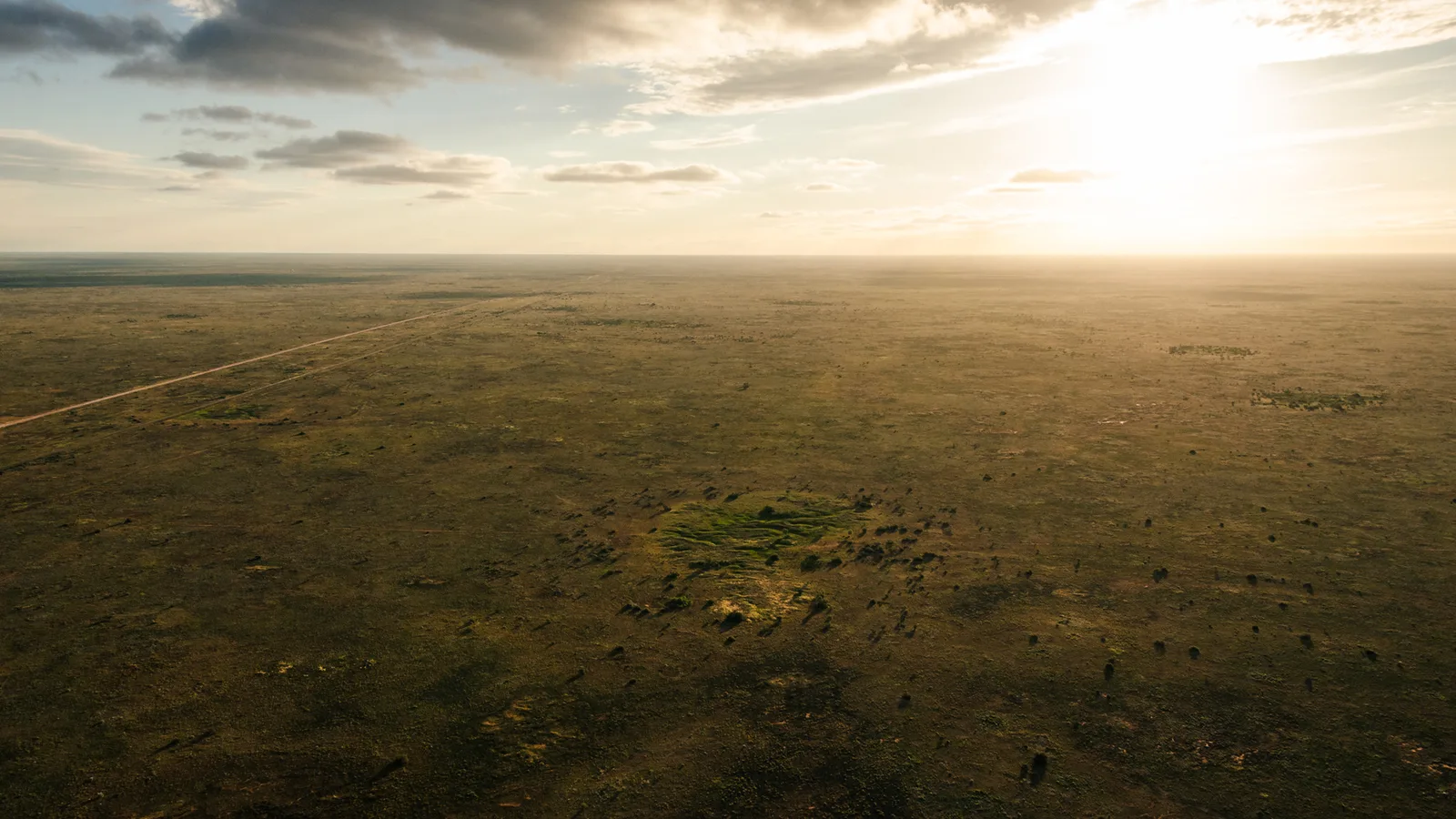 Aerial view of a flat rural landscape at sunset.
